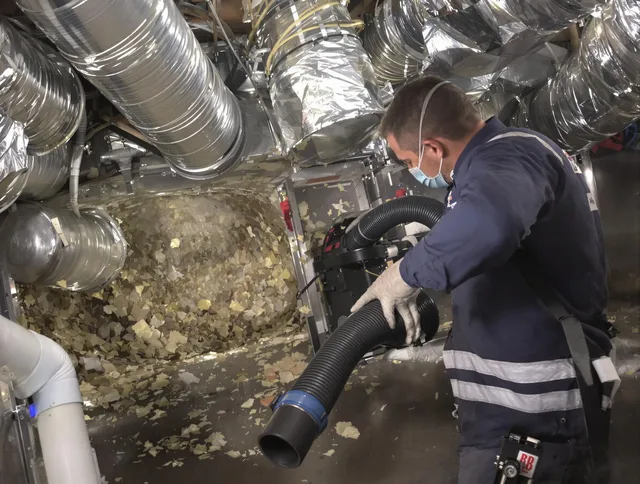 Tyngsborough Air Duct Cleaning specialist operating negative pressure cleaning equipment for thorough duct maintenance in Tyngsborough