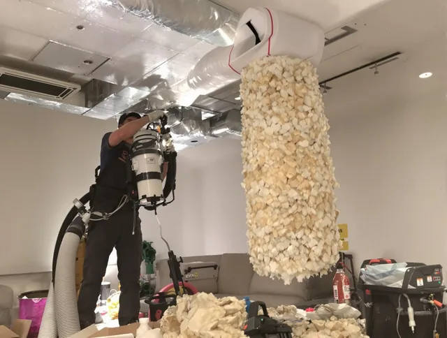 Tyngsborough Air Duct Cleaning technician performing precision vacuum insulation removal in a residential property in Tyngsborough